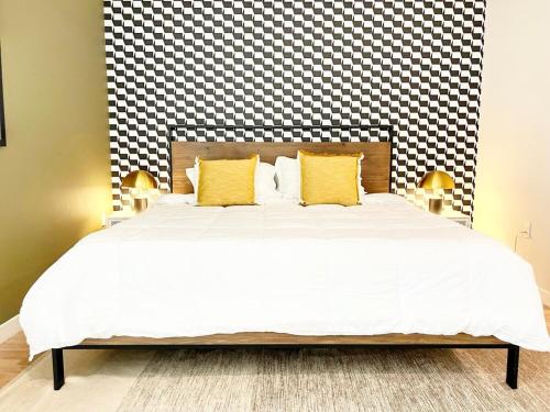 a bedroom with a large bed with yellow pillows at City View Apartment in Downtown! in San Diego