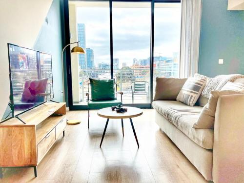a living room with a couch and a table at City View Apartment in Downtown! in San Diego