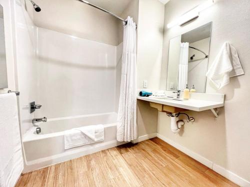 a bathroom with a tub and a sink and a shower at The Leo - One Bedroom Apartment W Private Balcony in San Diego