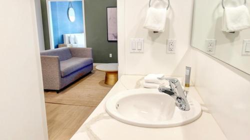 baño con lavabo y silla azul en Ambient Oasis In The Heart Of San Diego, en San Diego