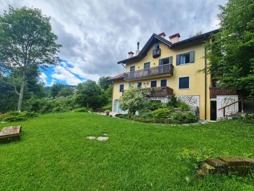 a large house with a green yard in front of it at Piccolo Paradiso in Foza