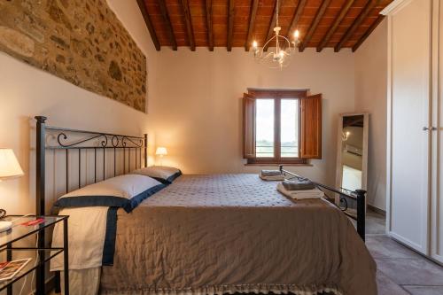 a bedroom with a large bed and a window at Vittoria Chianti Vacations in Poggibonsi
