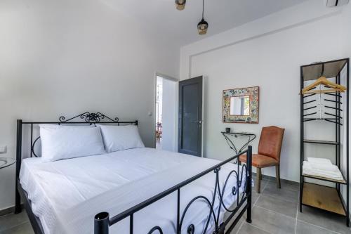 a bedroom with a bed and a chair at By the sea in Neo Klima