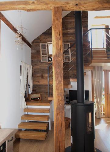 a living room with a woodburning stove and stairs at Relax house Aurora in Jasenovica
