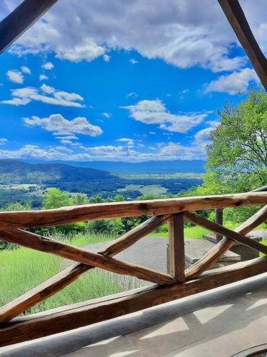 a wooden fence with a view of a field at Relax house Aurora in Jasenovica