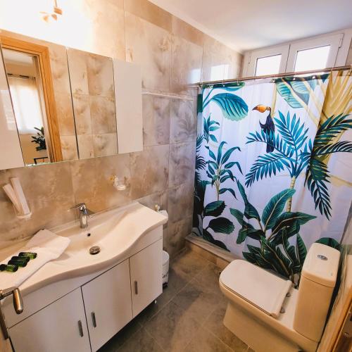 a bathroom with a sink and a shower curtain at Estrella Apartment in Sparta
