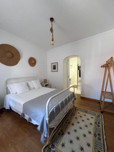 a bedroom with a large bed and a ladder at Casa do Pátio - Barragem do Alqueva in Granja