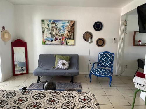 a living room with a couch and a chair at Cozy Studio near Coconut Grove in Miami