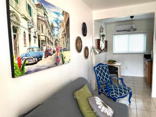 a living room with a painting on the wall at Cozy Studio near Coconut Grove in Miami
