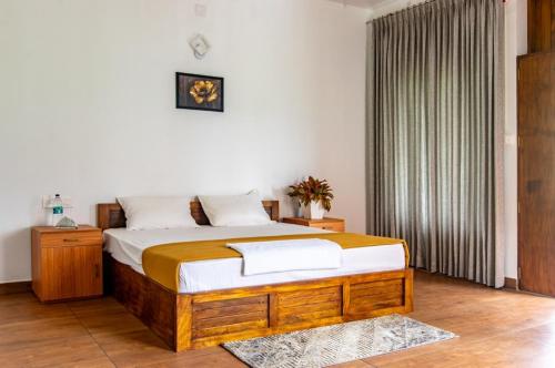 a bedroom with a bed and a large window at Vega Paradise in Kanthalloor