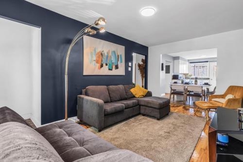 a living room with a couch and a table at Cozy 3 Bedrooms Montreal in Montréal