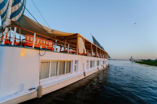 a cruise ship is docked on the water at Turquoise Dahabiya , 3,4,7 nights sailing between Luxor and Aswan in Luxor