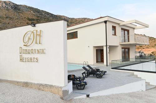 a house with a sign that reads ciot dermatologic heights at Villa Panorama - autumn luxury villa - heated pool and jacuzzi in Ivanica