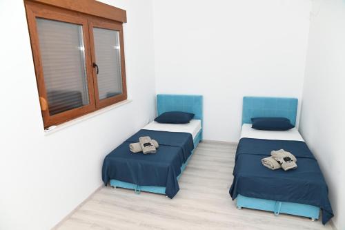 a room with two beds and a window at Villa Panorama - autumn luxury villa - heated pool and jacuzzi in Ivanica