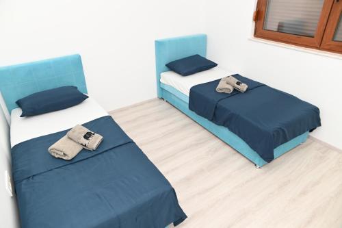 a room with two beds with towels on them at Villa Panorama - autumn luxury villa - heated pool and jacuzzi in Ivanica