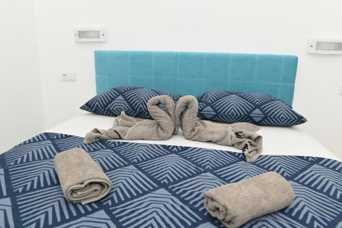 a bedroom with a bed with towels on it at Villa Panorama - autumn luxury villa - heated pool and jacuzzi in Ivanica