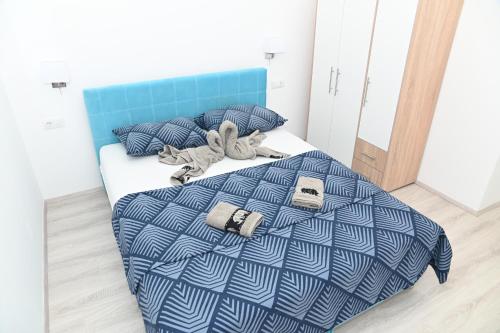 a bedroom with a bed with a blue comforter at Villa Panorama - autumn luxury villa - heated pool and jacuzzi in Ivanica