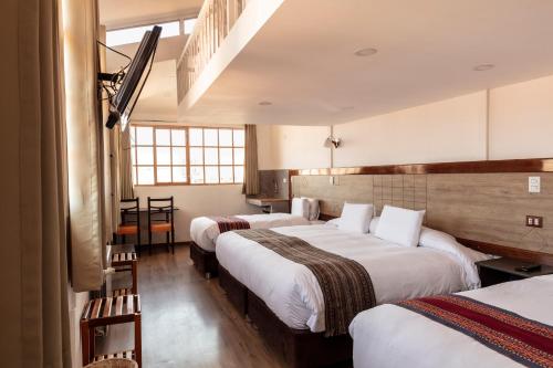 Katil atau katil-katil dalam bilik di MOAF Cusco Boutique Hotel