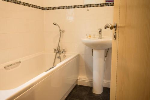 a bathroom with a sink and a bath tub and a sink at Farley in Matlock