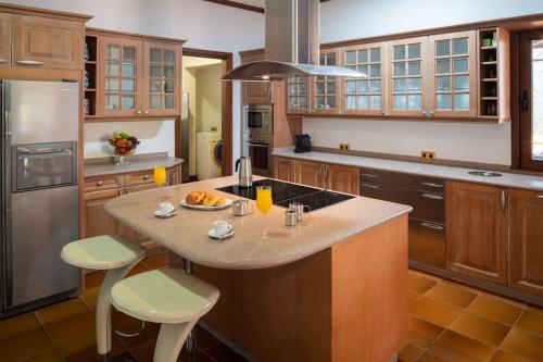 a kitchen with a large island with a counter top at TINDAYA by Buenavilla in Puerto Calero