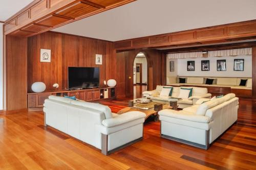 a living room with white couches and a television at TINDAYA by Buenavilla in Puerto Calero