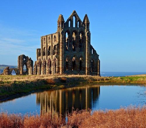an old castle on an island with a pond at Restored circus wagon in Saltburn-by-the-Sea