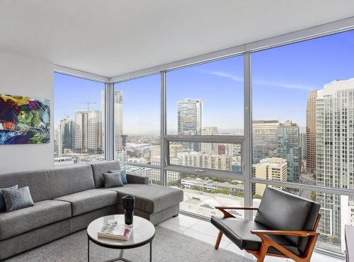 a living room with a couch and a large window at 2 Bed 2 Bath Contemporary High Rise DTLA Living in Los Angeles