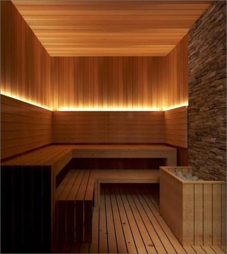 a sauna with a bench and a stone wall at 2 Bed 2 Bath Contemporary High Rise DTLA Living in Los Angeles