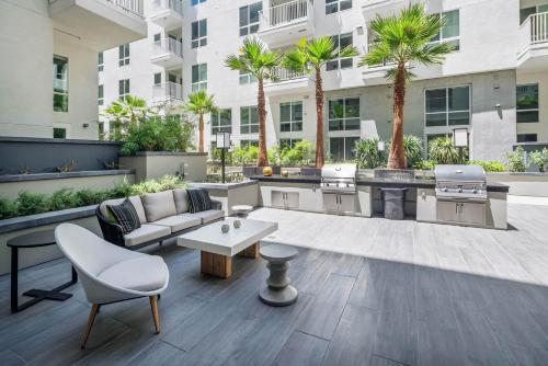 an outdoor patio with a couch and a table at 2 Bed 2 Bath Contemporary High Rise DTLA Living in Los Angeles