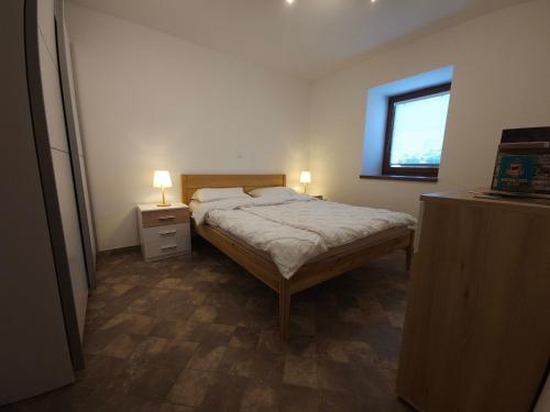 a small bedroom with a bed and a window at Apartment Kostanjevica na Krki in Kostanjevica na Krki