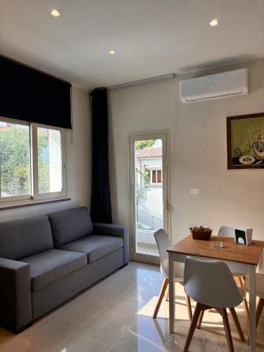 a living room with a couch and a table at IG - "Villa Don Antonio" Apartments in Giardini Naxos