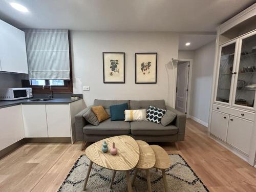 a living room with a couch and a table at Loft in Uribarri in Bilbao