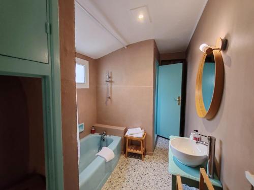 a bathroom with a tub and a sink and a bath tub at Hotel de France in Narbonne