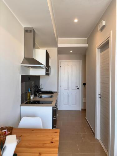 a kitchen with a sink and a stove at IG - "Villa Don Antonio" Apartments in Giardini Naxos