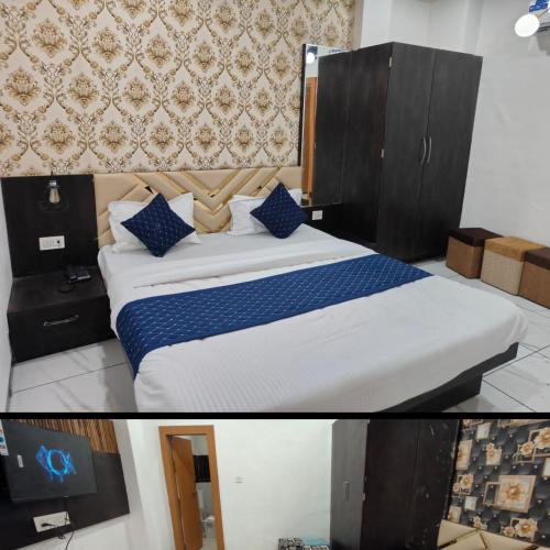 a bedroom with a large bed with blue pillows at RK Hotel & Restaurant in Dewās
