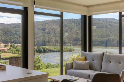 a living room with a couch and a large window at Casa Candales - Eladia in Cedeira