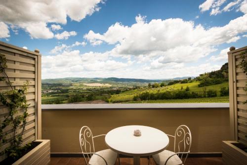 a table and chairs on a balcony with a view at Altarocca Wine Resort Adults Only in Orvieto