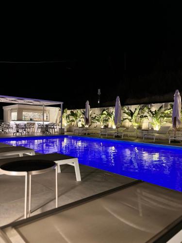 a swimming pool with a table and chairs at IG - "Villa Don Antonio" Apartments in Giardini Naxos
