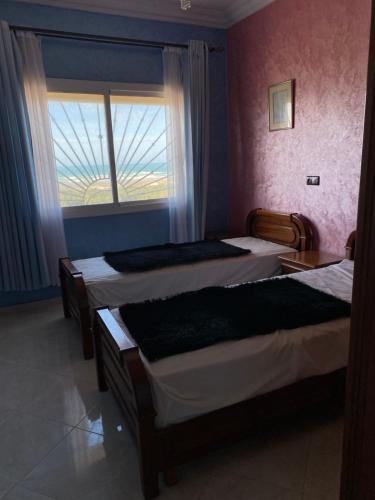 Postel nebo postele na pokoji v ubytování Appartement avec vue unique sur la plage