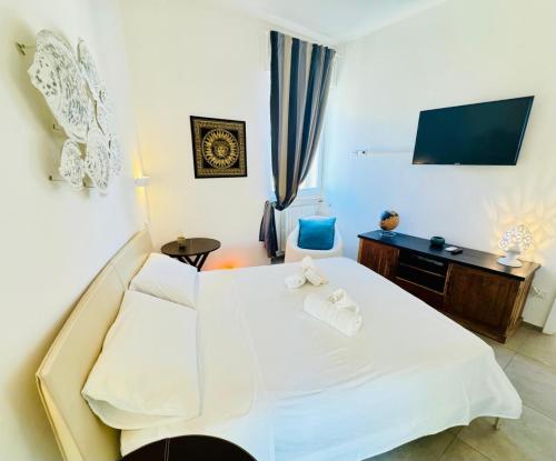 a bedroom with a white bed and a desk at Sibilla in Gallipoli