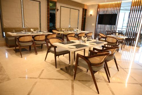 a dining room with tables and chairs in a restaurant at The Mudra Hotel in Varanasi