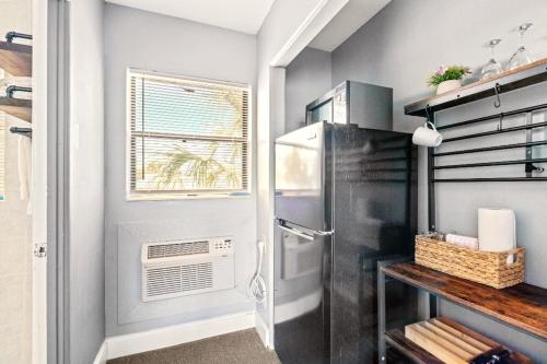 a kitchen with a refrigerator and a window at Boutique Beach Retreat in St Pete Beach