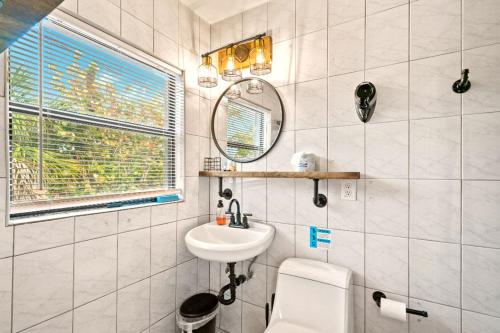 a bathroom with a sink and a mirror at Boutique Beach Retreat in St Pete Beach
