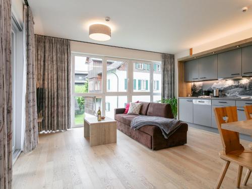 a living room with a couch and a large window at Apart33 Top 1-22 in Haus im Ennstal