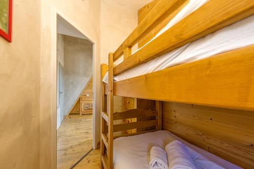two bunk beds in a room with a hallway at Homency - Chalet Jepima II in L'Alpe-d'Huez