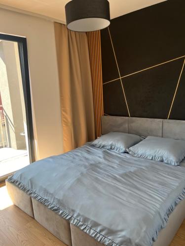 Ένα ή περισσότερα κρεβάτια σε δωμάτιο στο Apartament MARIA