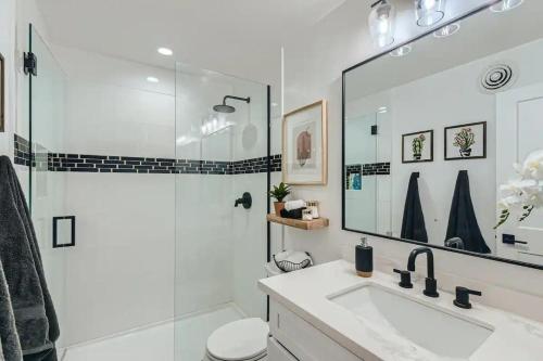 a white bathroom with a shower and a sink at Luxury Condo In Old Town Scottsdale Wpool in Scottsdale