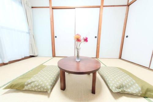 Una cama o camas en una habitación de 光アパートメント広島駅前 HIKARI Apartment Hiroshima Station
