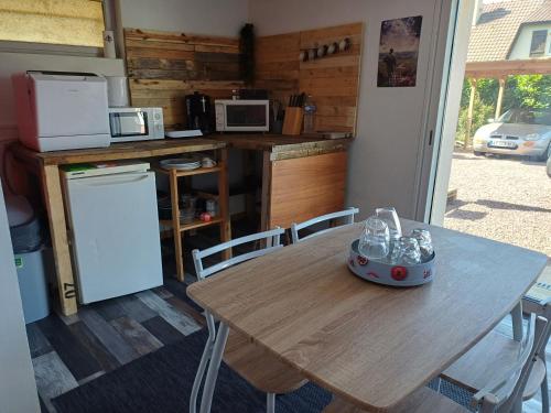 a wooden table in a kitchen with a table and chairs at Le val in Thaon