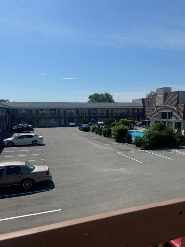 a parking lot with cars parked in front of a building at Niagara Lodge & Suites in Niagara Falls